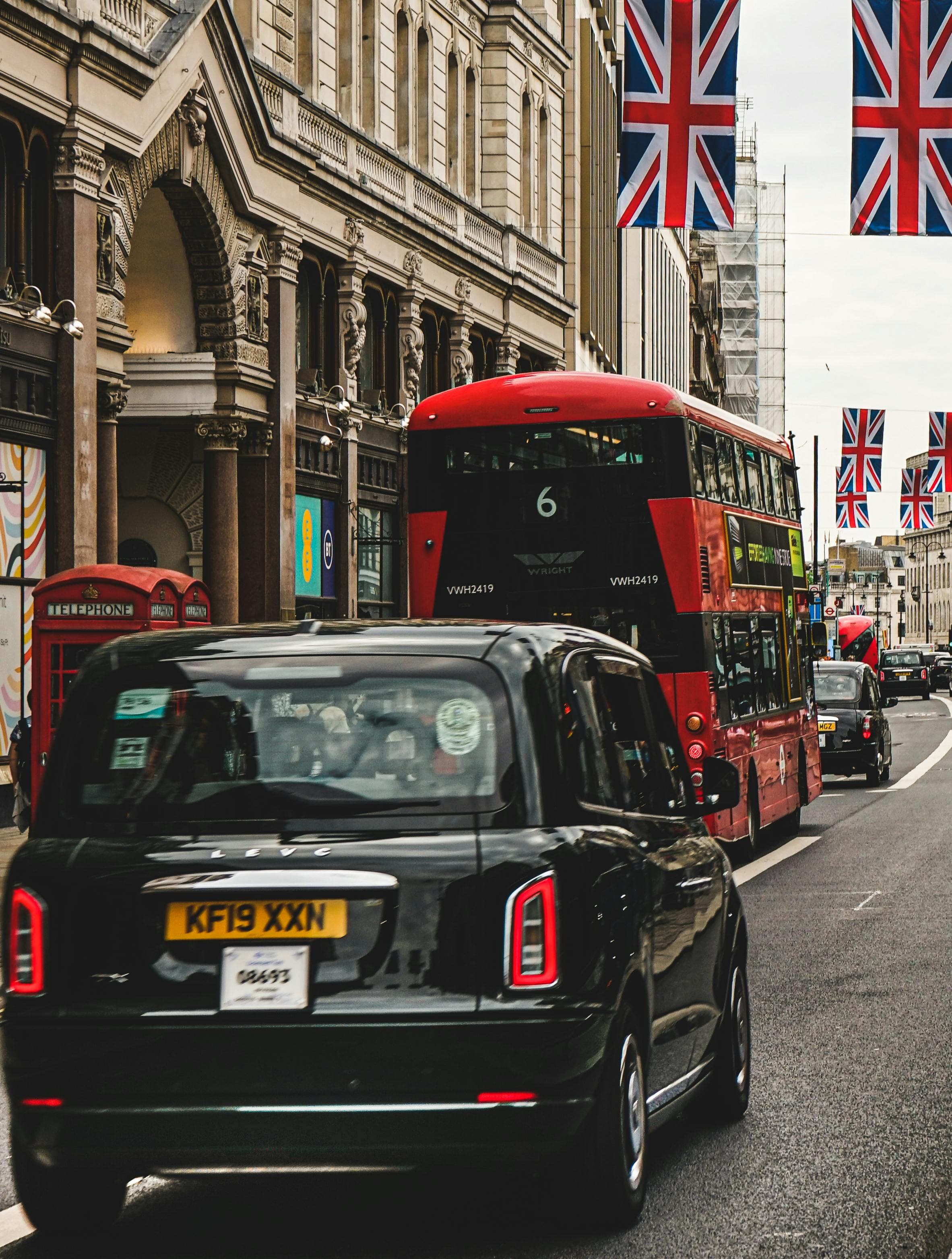 London street scene with buses and Union Jack flags